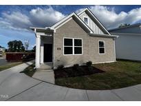 Gray brick ranch home with landscaping and walkway at 800 Dorset Stream Dr, Fuquay Varina, NC 27526