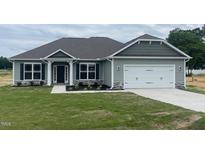 Charming one-story house with gray siding and a two-car garage at 90 Watermelon Dr, Franklinton, NC 27525