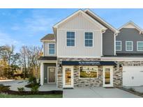 Two-story townhome with stone and siding exterior at 2232 Cherry Top Dr, Fuquay Varina, NC 27526