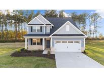 Two-story home with gray siding, white trim, and landscaping at 110 Merrifield Ln, Garner, NC 27529
