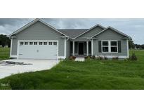 Gray house with a two-car garage and well-maintained lawn at 167 Lotus Ave, Smithfield, NC 27577