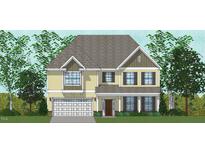 Two-story home with a light yellow exterior and white garage door at 116 Augusta Pond Way # 140, Raleigh, NC 27603