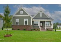 Front view of charming two-story home with green siding at 16 Autumn Breeze Ct, Angier, NC 27501