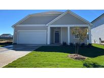 New home with gray siding, a white garage door and landscaping at 150 Chestnut Oak Ln, Lillington, NC 27546