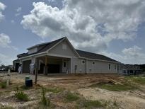 Exterior view of a beige house with a carport at 353 Village Walk Dr, Clayton, NC 27527