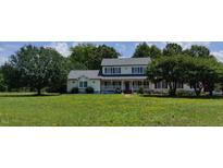 Two-story house with a large front yard, featuring a spacious porch and mature trees at 1525 Marshburn Rd, Wendell, NC 27591