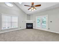 Bright living room featuring a fireplace and access to a balcony at 333 Glenolden Ct, Cary, NC 27513