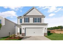 Two-story house with white siding and double garage at 209 River Bank Rd, Fuquay Varina, NC 27526