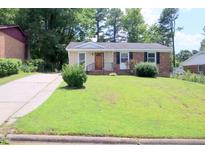 Brick ranch house with a well-manicured lawn at 1318 Timothy Avenue Ave, Durham, NC 27707