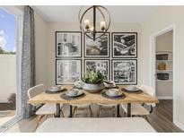 Modern dining room with a wood table, statement wall art, and access to a patio at 184 Pinkie Ln, Garner, NC 27529