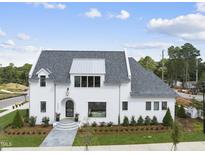 Stunning two-story home with white exterior and gray roof at 3300 Founding Place, Raleigh, NC 27612