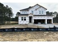 Two-story craftsman style home with gray siding, white trim, and a three-car garage at 536 Barbour Farm Ln, Four Oaks, NC 27524