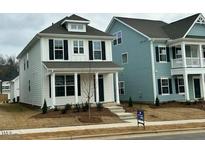 Two-story homes with modern design, featuring a neutral color palette and landscaping at 644 Georgia'S Landing Pkwy # 75, Raleigh, NC 27603