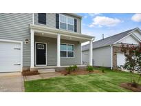 Two-story house with gray siding, white trim, and a covered front porch at 1716 Post Oak Dr, Haw River, NC 27258