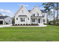 Two story white brick house with landscaping at 2506 Silas Peak Ln, Apex, NC 27523