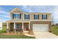 Two-story home with stone and siding exterior, two-car garage and landscaped lawn at 1713 Post Oak Dr, Haw River, NC 27258