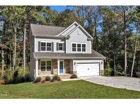 Two-story house with gray siding, stone accents, and a two-car garage at 900 Sw Maynard Rd, Cary, NC 27511