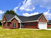 Brick ranch home with two-car garage and green lawn at 3701 Greystone Dr, Rocky Mount, NC 27804