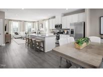 Open concept kitchen with island and stainless steel appliances at 1222 Helms St, Durham, NC 27713