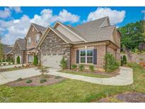 Brick townhouse with a two-car garage and landscaping at 1051 Talisker Way # 18, Burlington, NC 27215