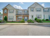 Townhouse exterior with a charming front entrance and well-maintained landscaping at 8107 Candelaria Dr, Raleigh, NC 27616