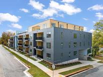 Modern building with multiple units and street parking at 29 Enterprise St # 211, Raleigh, NC 27607