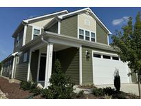 Two story green house with white garage door at 146 Swain St, Clayton, NC 27527