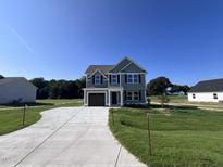Two-story house with gray siding and attached garage at 218 Lotus Ave, Smithfield, NC 27577