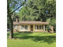 Brick ranch house with a well-maintained lawn at 1209 Beverly Dr. Dr, Raleigh, NC 27610