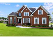 Brick two-story house with a landscaped lawn at 19 Silverside Dr, Angier, NC 27501