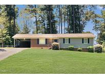 Brick ranch home with a large grassy yard at 2400 Carbonton Rd, Sanford, NC 27330