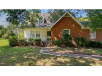 Brick ranch house with a front porch and landscaping at 1072 N Nc 87, Elon, NC 27244