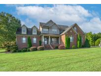 Brick house exterior with lush lawn and landscaping at 3105 W Hampton Dr, Rocky Mount, NC 27804