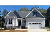 One-story house with gray siding, gray roof, and a two-car garage at 35 Courtland Dr, Louisburg, NC 27549
