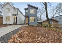 Modern two-story home with gray and white siding, landscaped yard, and a concrete driveway at 2708 A Ashley St, Durham, NC 27704