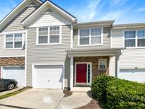 Attractive two-story townhome with a red front door and attached garage at 5107 Sandy Banks Rd, Raleigh, NC 27616
