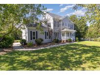 Two-story house with a landscaped lawn and attached garage at 203 Willow Ct, Angier, NC 27501