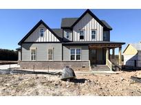 Two story home with gray siding and black accents at 100 Firefly Ln, Louisburg, NC 27549