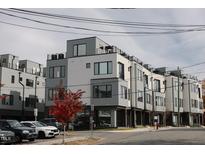 Modern townhouses with sleek gray siding and rooftop decks at 3005 Corbell Rd, Durham, NC 27701