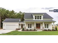 Charming farmhouse-style home with a large front porch at 198 Farmstead Ct, Wendell, NC 27591