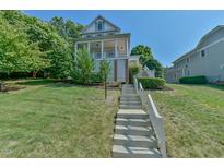 Two-story house with a wrap-around porch and landscaping at 407 Weaver Mine Trl, Chapel Hill, NC 27517