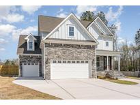 Two-story house with stone accents, and a two-car garage at 600 Darian Woods Drive,, Holly Springs, NC 27540