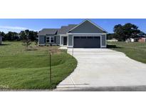 Gray house with attached garage and concrete driveway at 98 Lotus Ave, Smithfield, NC 27577