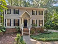 Two-story house with gray siding and brick base at 114 Canterfield Rd, Cary, NC 27513