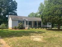 Ranch-style home with covered porch and landscaped yard at 910 Vanco Mill Rd, Henderson, NC 27537