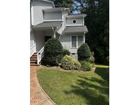 White two story house with brick walkway and landscaping at 492 Beechmast, Pittsboro, NC 27312
