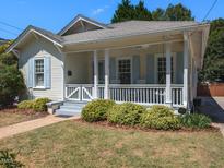 Charming one-story home with a front porch and landscaping at 209 E Whitaker Mill Rd, Raleigh, NC 27608