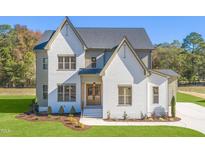 Two-story house with white brick and a gray roof at 212 Meadow Walk Dr, Fuquay Varina, NC 27526