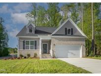 Brick home with gray siding, 2-car garage, and landscaped lawn at 902 Sw Maynard Rd, Cary, NC 27511