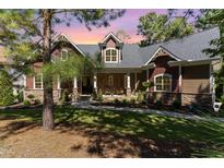 Two-story home with stone accents and a large front porch at 9 Mist Wood Court, Pittsboro, NC 27312